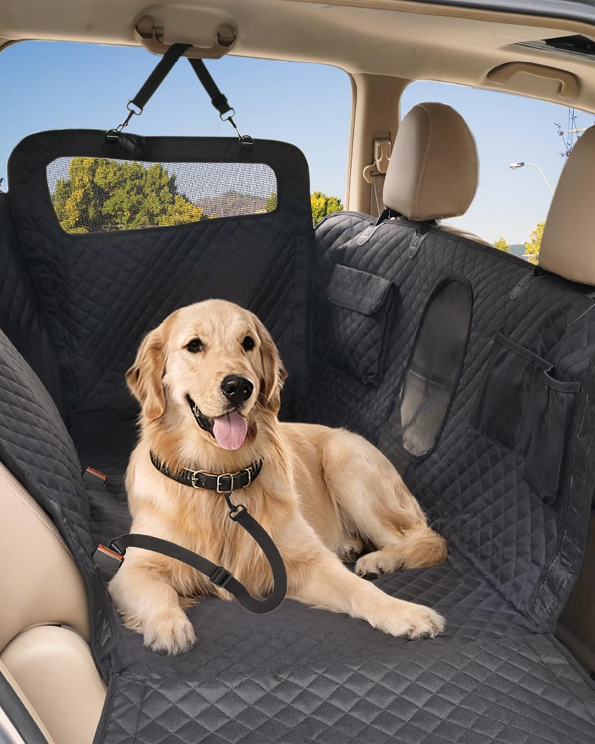 Golden retriever resting on a quilted waterproof dog back seat cover with mesh window in an SUV.