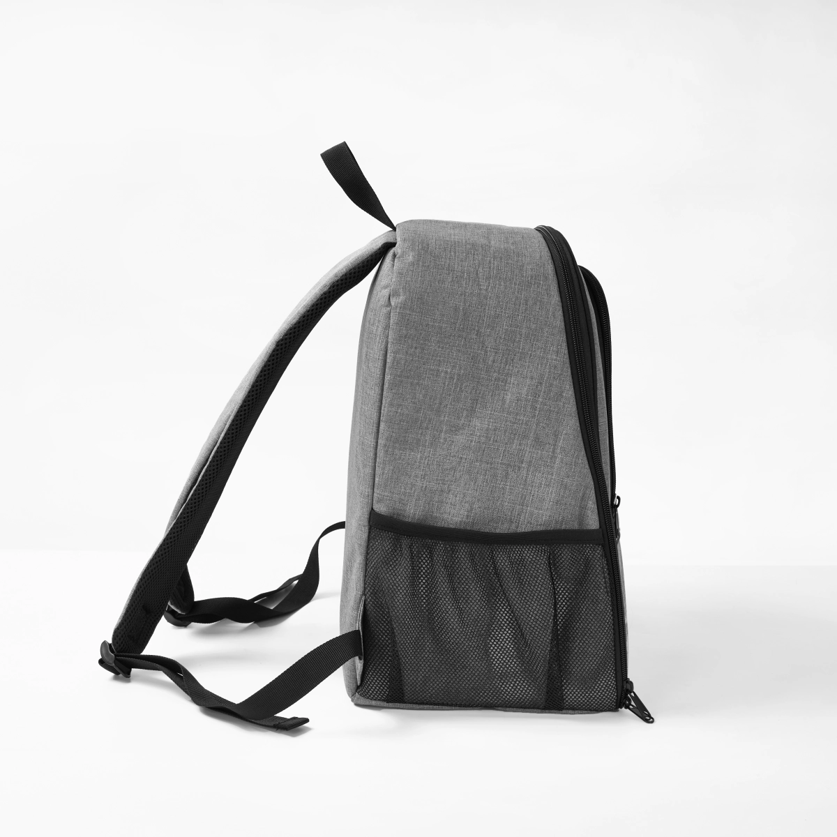 Side view of a StridePaw gray pet backpack carrier with side mesh pocket and padded straps