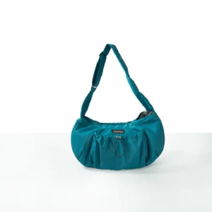 Front view of a StridePaw wearable nylon pet sling bag in teal with an adjustable wide strap and front zip storage pocket for small dogs and cats